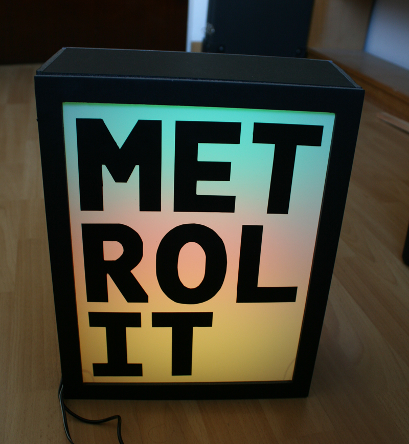 A colourful lightbox with the backlit text METROLIT